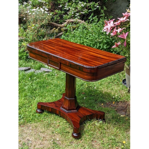 244 - A VERY FINE REGENCY ROSEWOOD FOLD OVER CARD TABLE, the rounded body decorated with gadrooned detail ... 