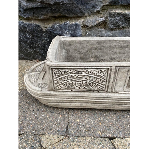 246 - A PAIR OF STONE GARDEN PLANTERS, in the form of boats, reading ‘Lucy Anne’ with floral designs to si... 