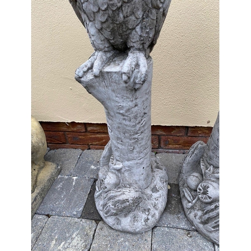 247 - A PAIR OF STONE GARDEN FIGURES, in the form of parrots on tree stumps, dimensions: 89cm high approx