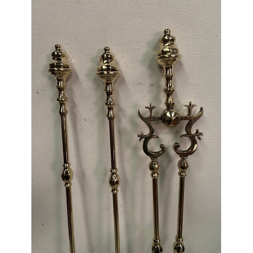 256 - A FINE SET OF THREE VICTORIAN POLISHED BRASS FIRE IRONS, with dogs, all with decorative finials, tur... 