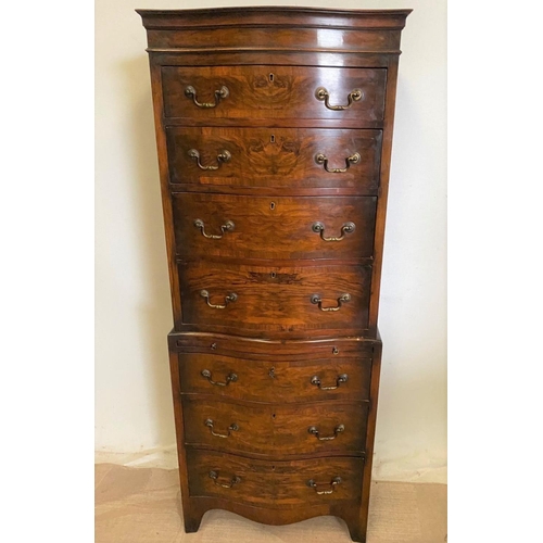 260 - A WALNUT SERPENTINE CHEST ON CHEST, with shaped cornice, four above three drawers with brass handles... 