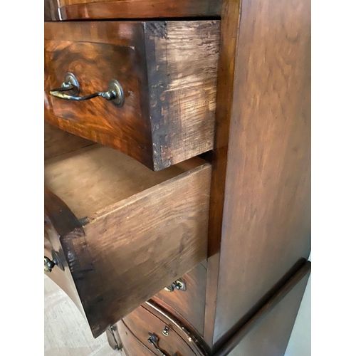 260 - A WALNUT SERPENTINE CHEST ON CHEST, with shaped cornice, four above three drawers with brass handles... 