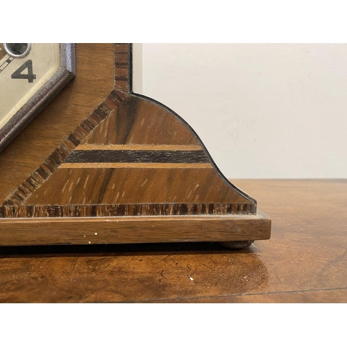 262 - AN ART DECO HARDWOOD INLAID MANTLE CLOCK, octagonal form with fine crossbanded details, on base with... 