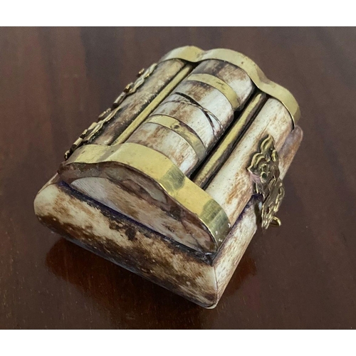 264 - A UNIQUE BONE AND BRASS BOUND JEWELLERY BOX, brass binding shaped box, with engraved clasp.