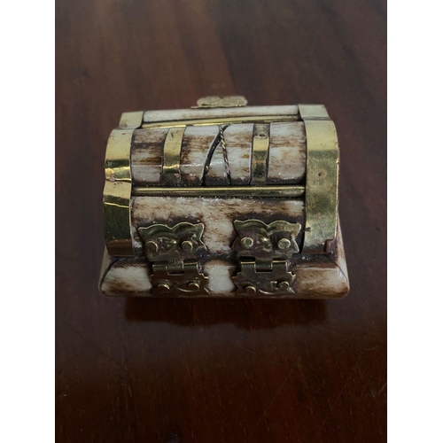 264 - A UNIQUE BONE AND BRASS BOUND JEWELLERY BOX, brass binding shaped box, with engraved clasp.