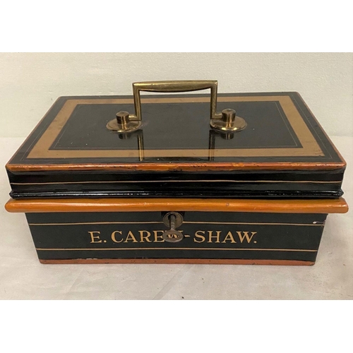 267 - AN ANTIQUE PAINTED STEEL MONEY BOX, with brass handle, fitted interior and original key. Reading ‘E.... 