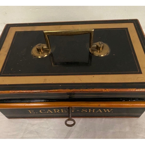 267 - AN ANTIQUE PAINTED STEEL MONEY BOX, with brass handle, fitted interior and original key. Reading ‘E.... 