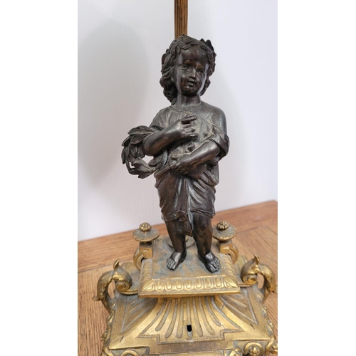 288 - A PAIR OF HEAVY PATINATED BRONZE & GILT CAST TABLE LAMPS, each with a small figure, one holding a mu... 