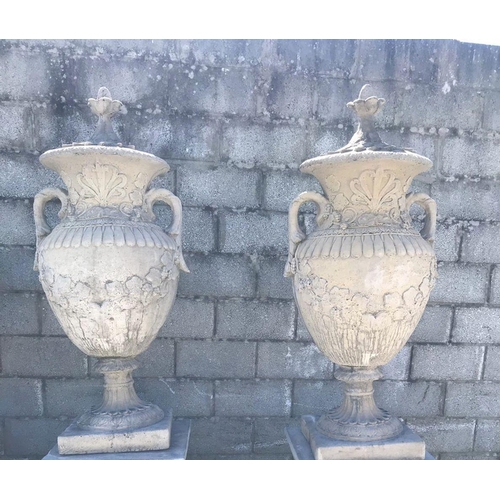 289 - A PAIR OF TWO LARGE GARDEN ORNAMENTS IN THE FORM OF URNS with lids, 5ft tall approximately.