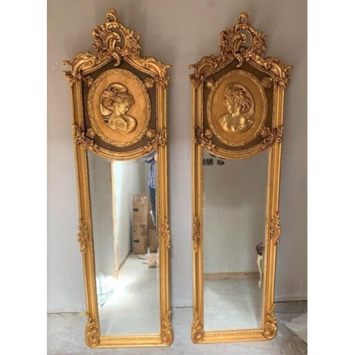 291 - A PAIR OF GILT WALL MIRRORS, each decorated with scrolling foliage design and picture panels showing... 