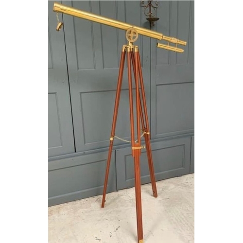 292 - A CONTEMPROARY DECORATIVE BRASS & WOOD TELESCOPE ON A STAND, 5ft tall approximately.