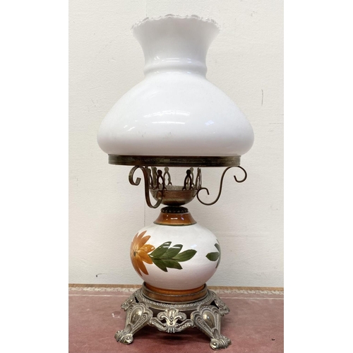 30 - A VINTAGE PAINTED GLASS HURRICANE LAMP, with shaped brass frame and base, finely decorated standing ... 