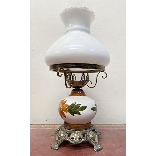 30 - A VINTAGE PAINTED GLASS HURRICANE LAMP, with shaped brass frame and base, finely decorated standing ... 