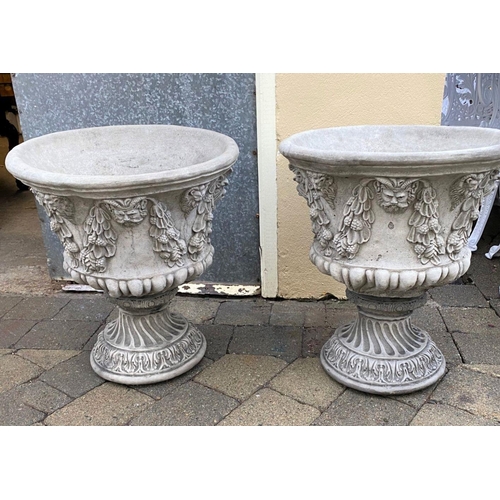 308 - A PAIR OF STONE GARDEN URNS, finely formed with decorative figural & grape leaf design in relief sur... 