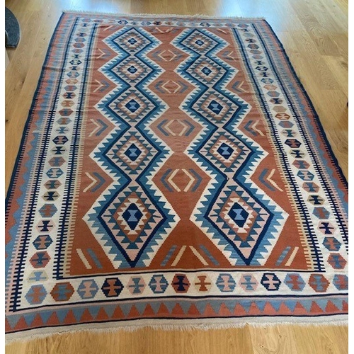 309 - A LARGE VIBRANT KELLIM RUG, wool, with geometric diamond pattern in blue, orange and navy on white g... 