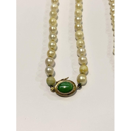 312 - TWO LOVELY PEARL NECKLACES, (i) one strand with 14ct gold clasp with green enamel to centre, (ii) a ... 