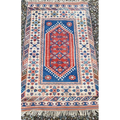 319 - A MID CENTURY TURKISH RUG, hand-made with triple motif to centre surrounded by multiple geometric pa... 