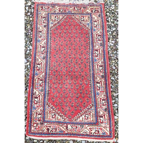 320 - A VINTAGE PERSIAN HAMADAN RUG, with repeat geometric design to centre, within multiple patterned bor... 