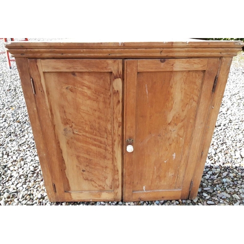 331 - A VICTORIAN PINE HANGING CORNER CABINET, with fluted cornice above panelled doors with porcelain kno... 