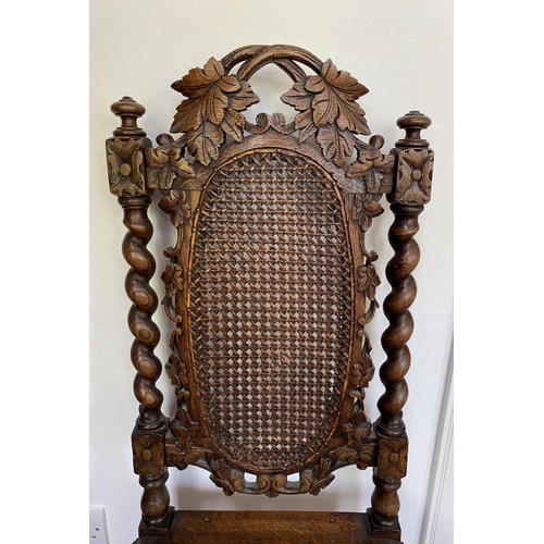 38 - AN ANTIQUE OAK CARVED JACOBEAN CHAIR, with woven seat and oval panel to backsplat, surrounded by orn... 