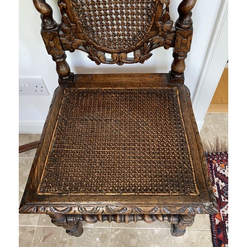 38 - AN ANTIQUE OAK CARVED JACOBEAN CHAIR, with woven seat and oval panel to backsplat, surrounded by orn... 