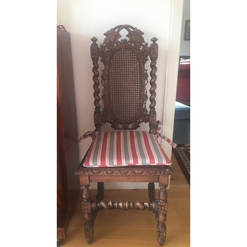 38 - AN ANTIQUE OAK CARVED JACOBEAN CHAIR, with woven seat and oval panel to backsplat, surrounded by orn... 