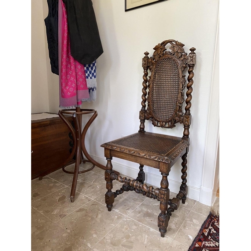 38 - AN ANTIQUE OAK CARVED JACOBEAN CHAIR, with woven seat and oval panel to backsplat, surrounded by orn... 