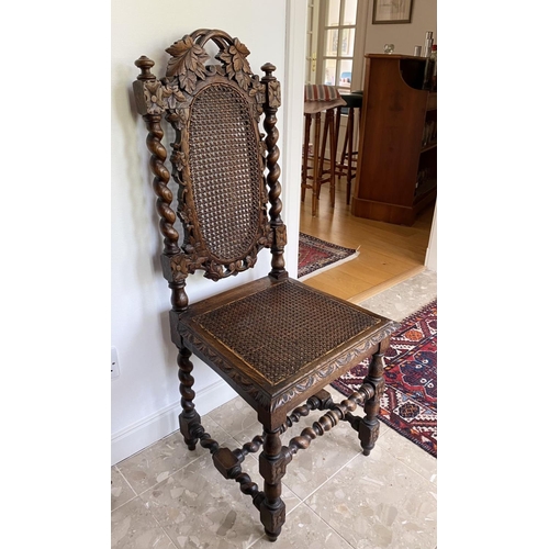 38 - AN ANTIQUE OAK CARVED JACOBEAN CHAIR, with woven seat and oval panel to backsplat, surrounded by orn... 