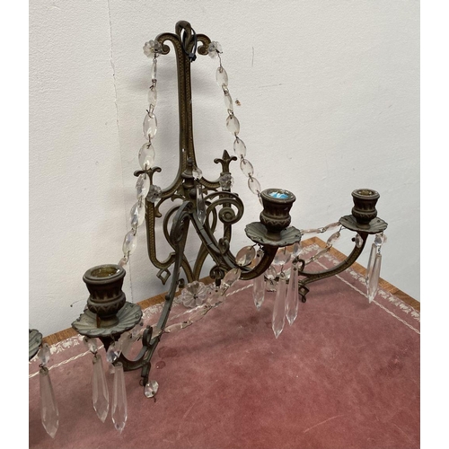 46 - A PAIR OF ANTIQUE BRONZE CRYSTAL WALL SCONCES, with three branches, shaped frame and hanging prisms.... 