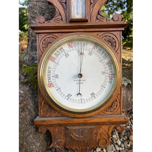 48 - AN ANTIQUE MCPHERSON BROTHERS GLASGOW WHEEL BAROMETER, in finely carved hardwood frame. Dial reading... 