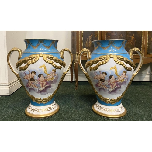 56 - A PAIR OF SERVES PORCELAIN TWO HANDLES URN VASES, with painted panels to front and reverse depicting... 