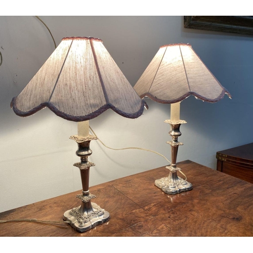 59 - A PAIR OF FINE SILVER PLATED TABLE LAMPS, turned column supports with floral scrolling decoration, s... 