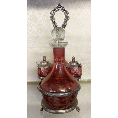 65 - AN ANTIQUE CRANBERRY GLASS CRUET SET, with two etched cranberry glass decanters with globe stoppers,... 