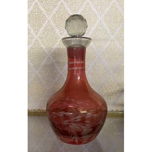 65 - AN ANTIQUE CRANBERRY GLASS CRUET SET, with two etched cranberry glass decanters with globe stoppers,... 