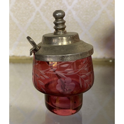 65 - AN ANTIQUE CRANBERRY GLASS CRUET SET, with two etched cranberry glass decanters with globe stoppers,... 