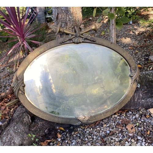 66 - AN ANTIQUE FRENCH STYLE OVAL GILT MIRROR, with bevelled glass, mounted to top by torch flame crest. ... 