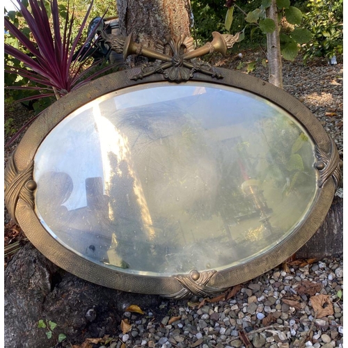 66 - AN ANTIQUE FRENCH STYLE OVAL GILT MIRROR, with bevelled glass, mounted to top by torch flame crest. ... 