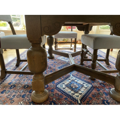 7 - A WONDERFUL SOLID OAK DINING TABLE ALONG WITH CHAIRS, table with turned legs, carving to frieze, tur... 