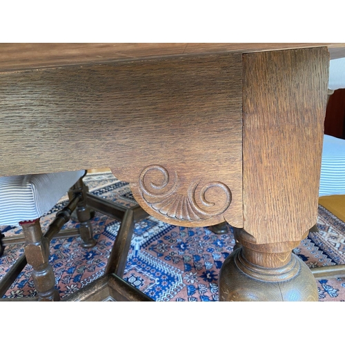 7 - A WONDERFUL SOLID OAK DINING TABLE ALONG WITH CHAIRS, table with turned legs, carving to frieze, tur... 