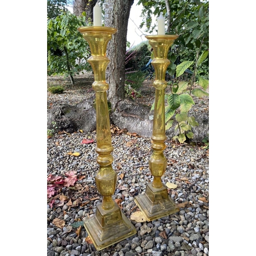 71 - A PAIR OF LARGE VINTAGE GLASS CANDLESTICKS, coloured glass, with turned supports on graduated square... 