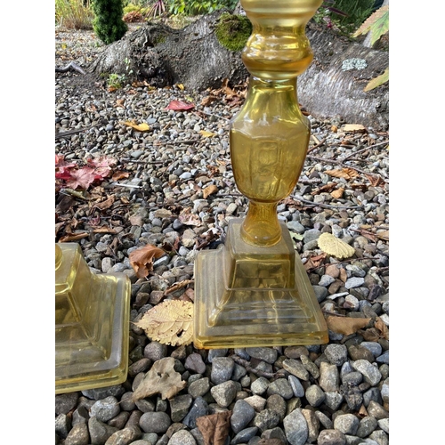 71 - A PAIR OF LARGE VINTAGE GLASS CANDLESTICKS, coloured glass, with turned supports on graduated square... 