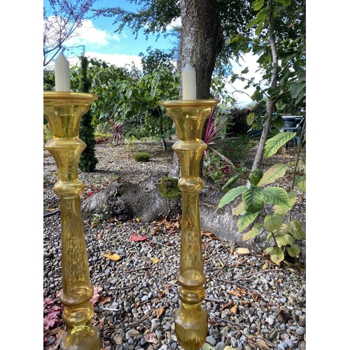 71 - A PAIR OF LARGE VINTAGE GLASS CANDLESTICKS, coloured glass, with turned supports on graduated square... 