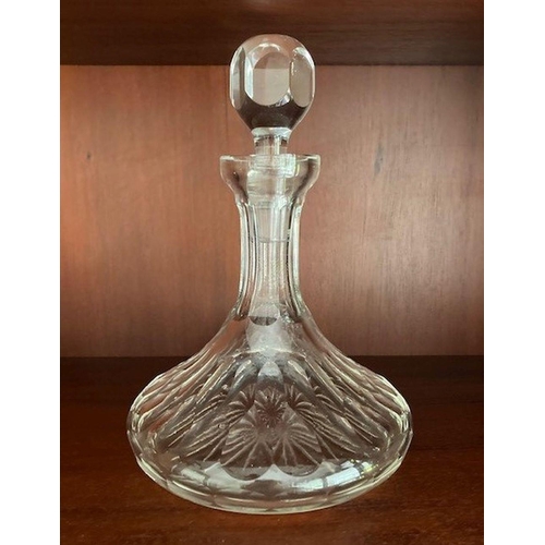 73 - A GOOD QUALITY CUT GLASS SHIPS DECANTER, with stopper, the body decorated with broad fluted cuts and... 