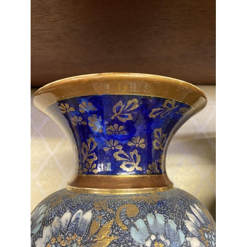 76 - A PAIR OF ROYAL DOULTON VASES, with painted blue neck and base, body decorated with white, gold and ... 