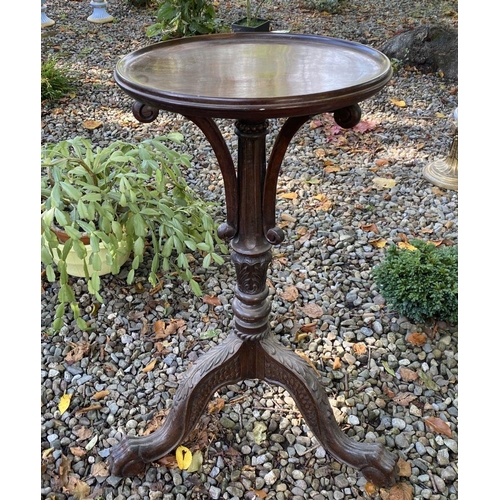 77 - AN ANTIQUE MAHOGANY WINE TABLE, with circular top, turned column with scroll supports, atop tripod b... 