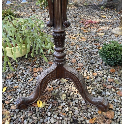 77 - AN ANTIQUE MAHOGANY WINE TABLE, with circular top, turned column with scroll supports, atop tripod b... 