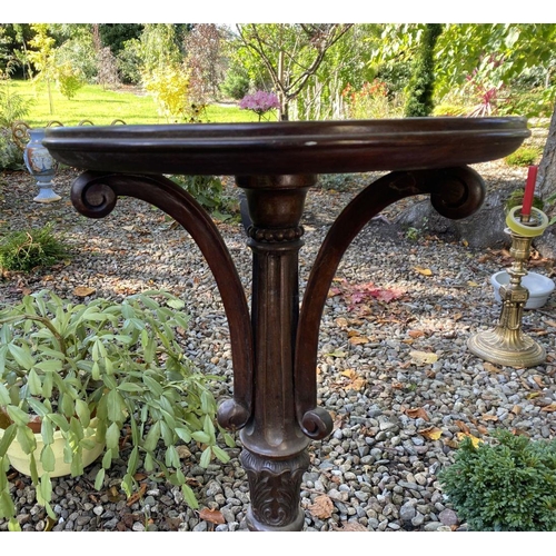 77 - AN ANTIQUE MAHOGANY WINE TABLE, with circular top, turned column with scroll supports, atop tripod b... 