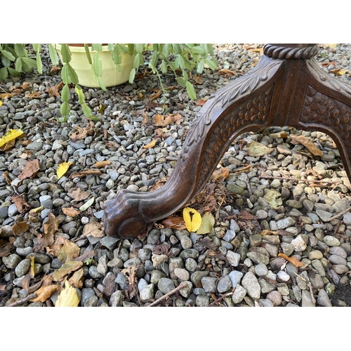 77 - AN ANTIQUE MAHOGANY WINE TABLE, with circular top, turned column with scroll supports, atop tripod b... 