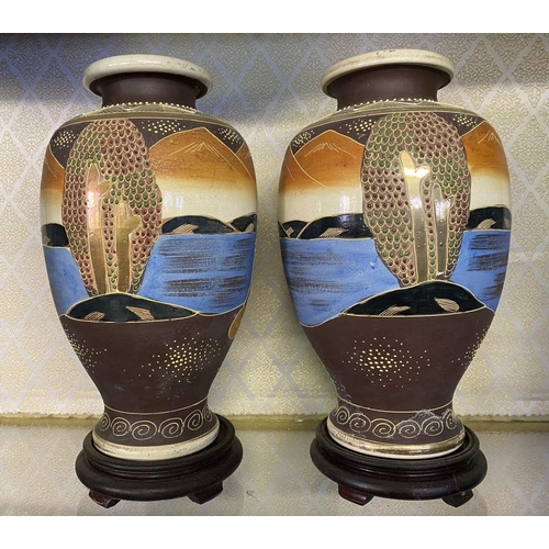 78 - A PAIR OF ANTIQUE JAPANESE SATSUMA VASES, baluster form, complete with circular hardwood bases. Fine... 