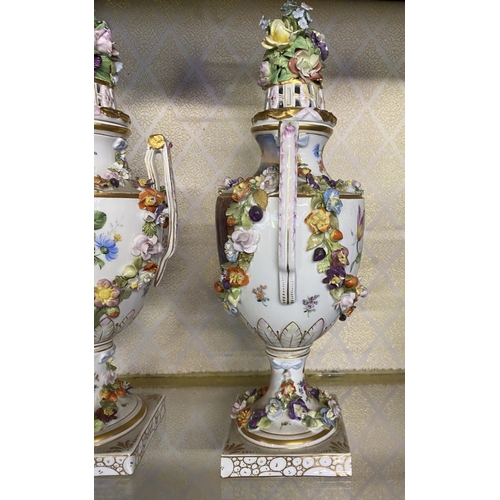 80 - A PAIR OF ORNATE MEISSEN PORCELAIN URN VASES ON PLYNTHS, classical urn form, finely decorated with p... 